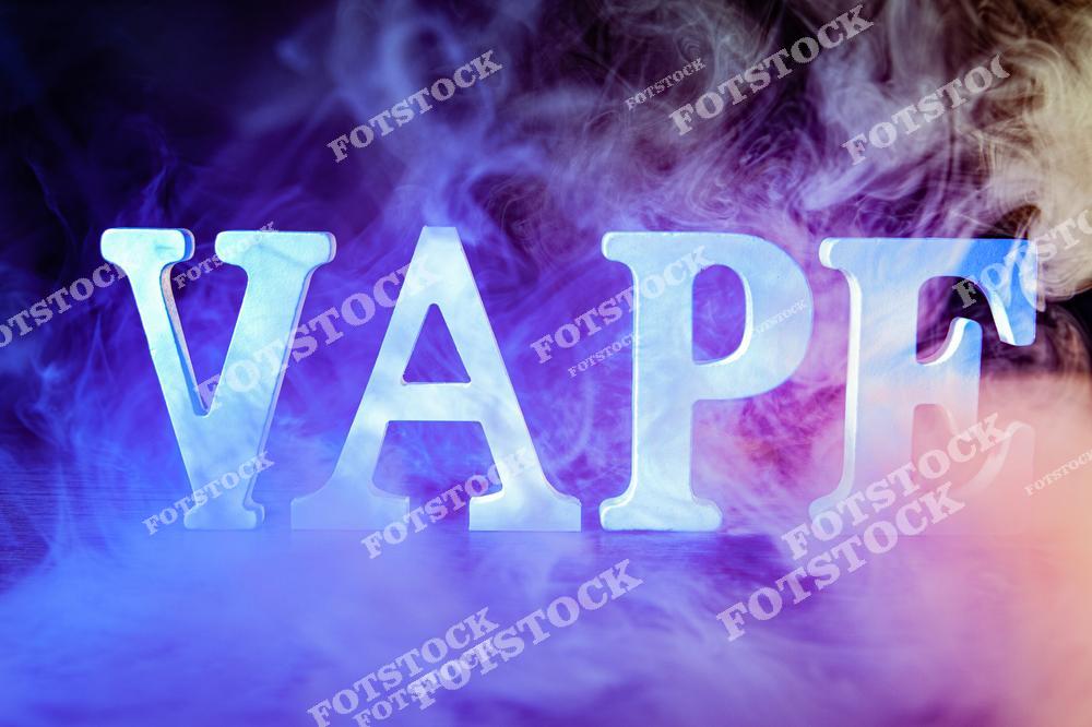 Стильное изображение белой надписи VAPE в густом дыму на ярком синем фоне. Атмосферная композиция передает современную vape-культуру, электронное курение и технологичный lifestyle. Дым, контрастные цвета и минималистичный дизайн делают изображение идеальным для рекламы vape shop, интернет-магазинов электронных сигарет и аксессуаров для вейпинга. Фотография отлично подходит для оформления сайтов, рекламных баннеров, публикаций о вейпинге и продвижения товаров для современных вейперов. Изображение может использоваться как фон для маркетинговых материалов и тематических проектов о vape-индустрии.